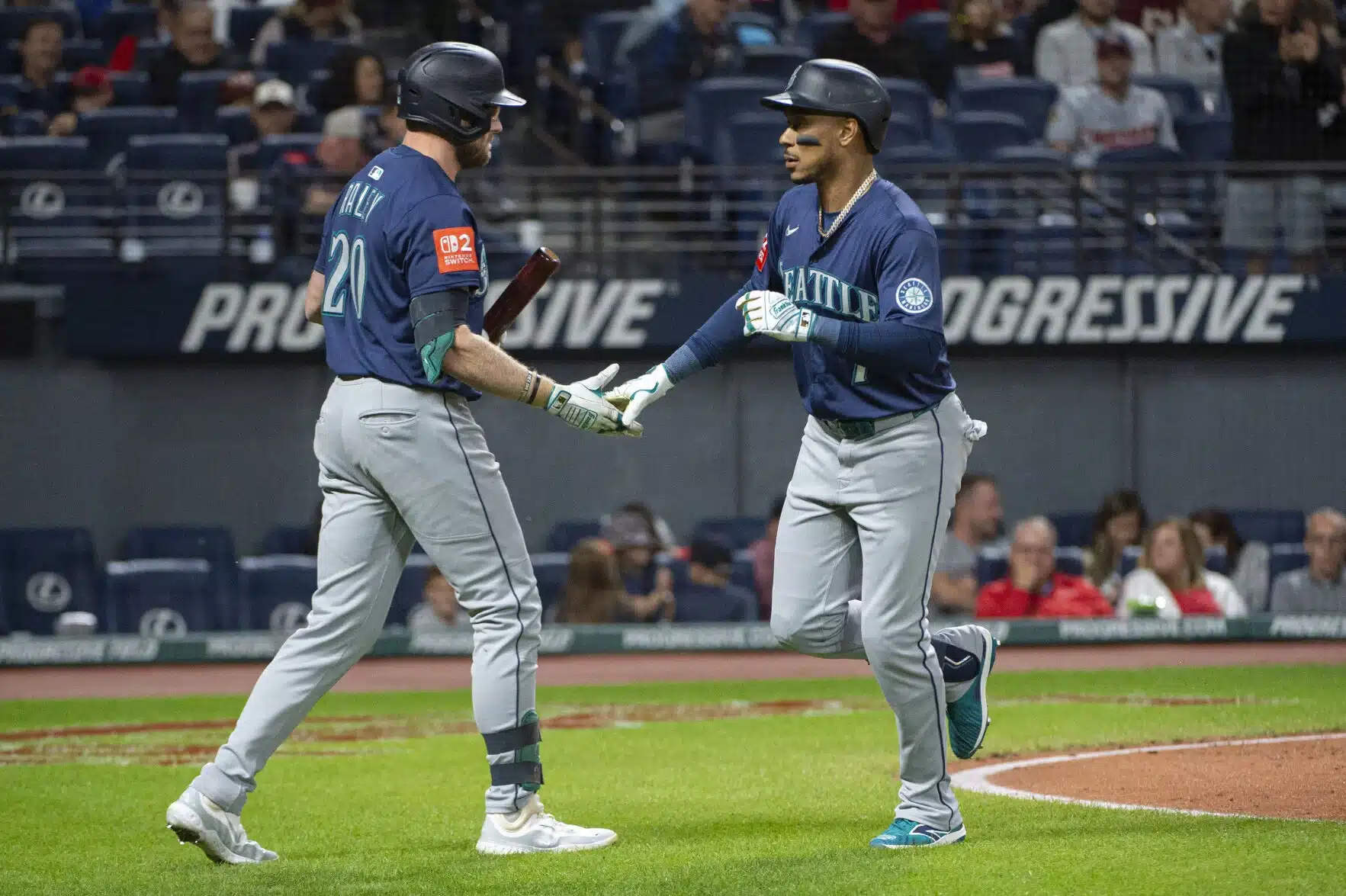 Two baseball mariners vs guardianss shaking hands on a field
