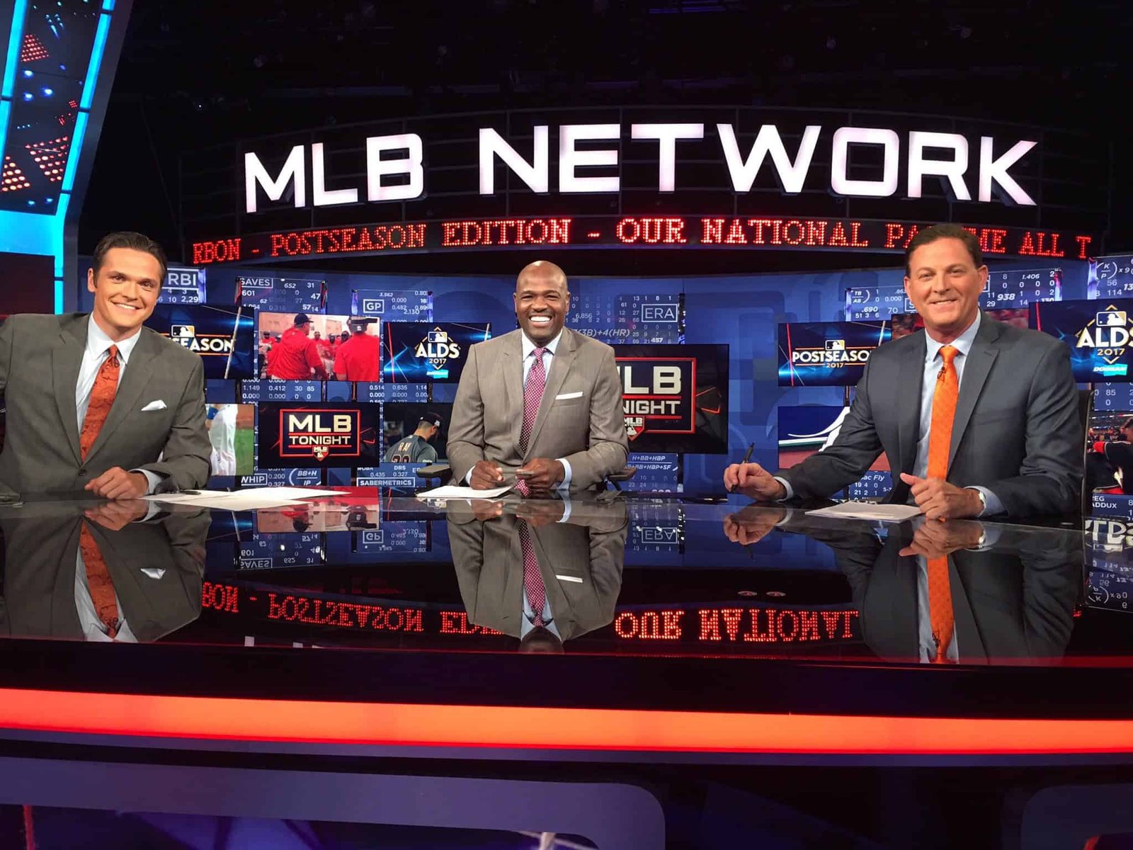 watch Royals Braves live - Three men in suits and ties stand on a television set