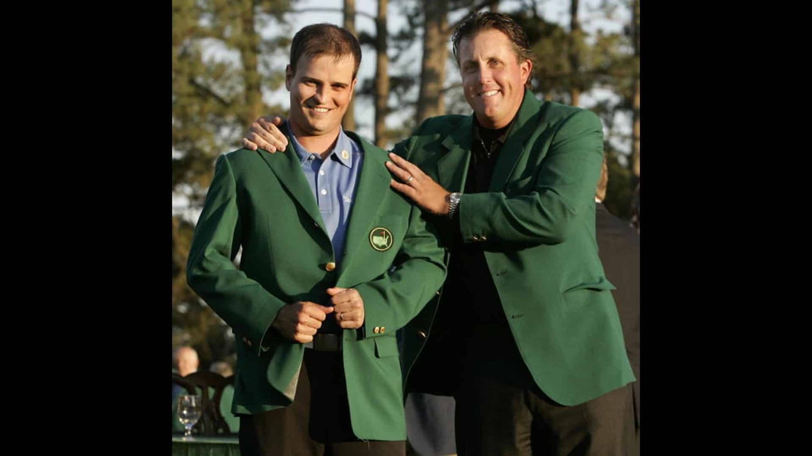 masters 2026 - Two men in green jackets and ties, one is pointing his finger at the other