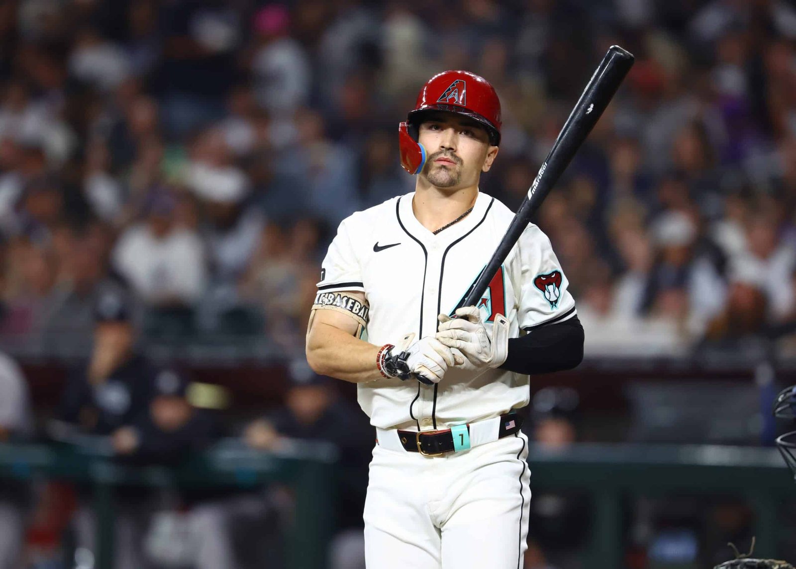 A baseball Corbin Carroll live holding a bat in a stadium