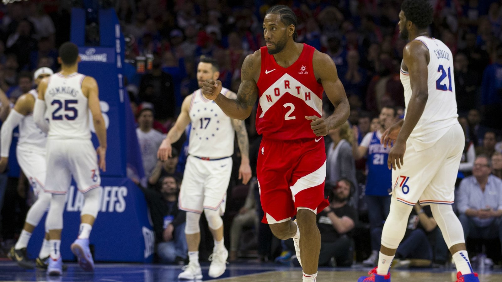 sports on tv today - A man in a red jersey is playing basketball