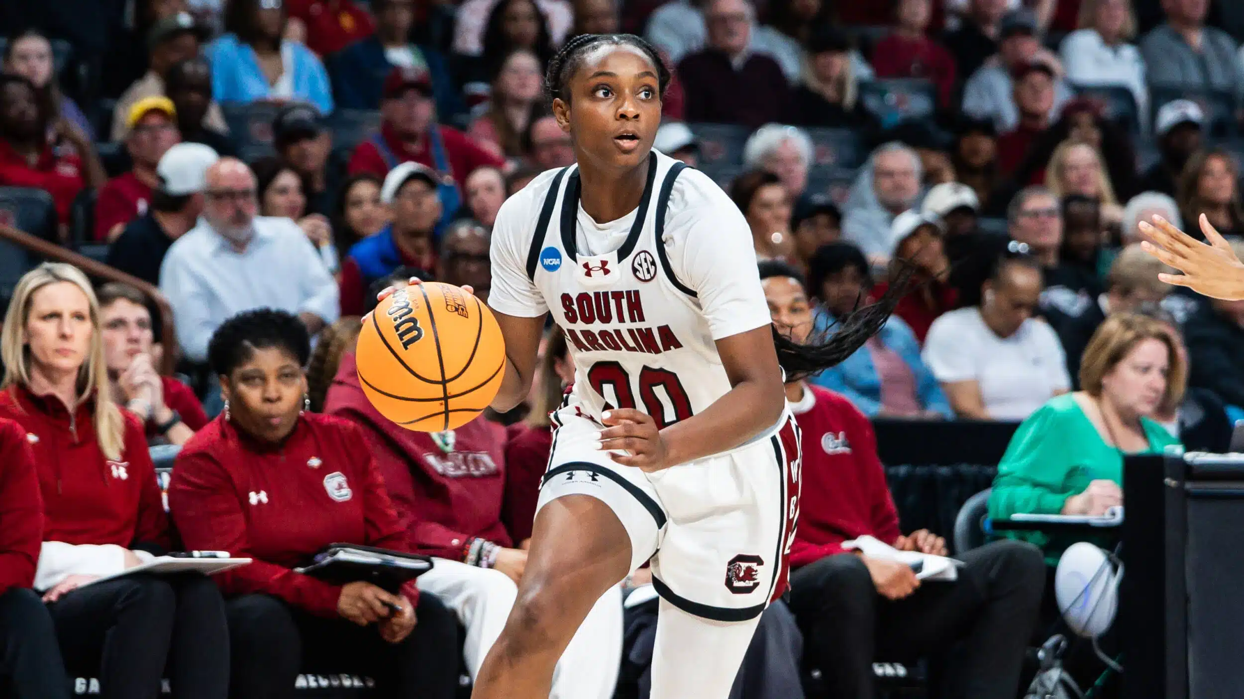 "south carolina vs uconn women's basketball stream - A woman in a white uniform holding a basketball ball