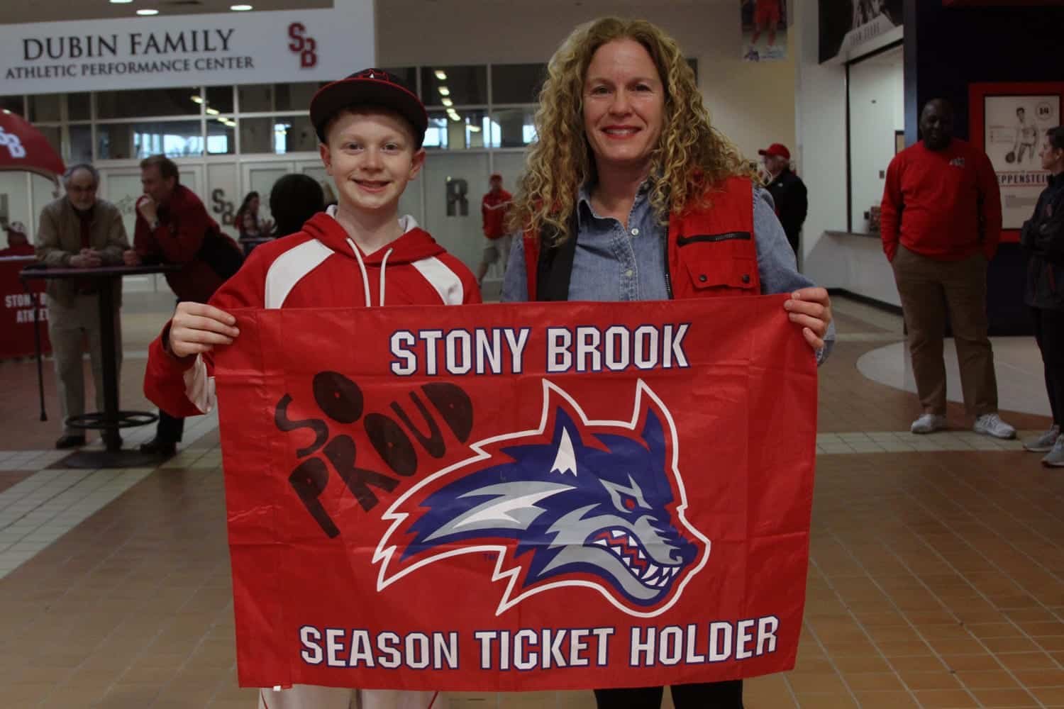 UNC Wilmington Seahawks vs Stony Brook Seawolves - A woman holding a red and white sign